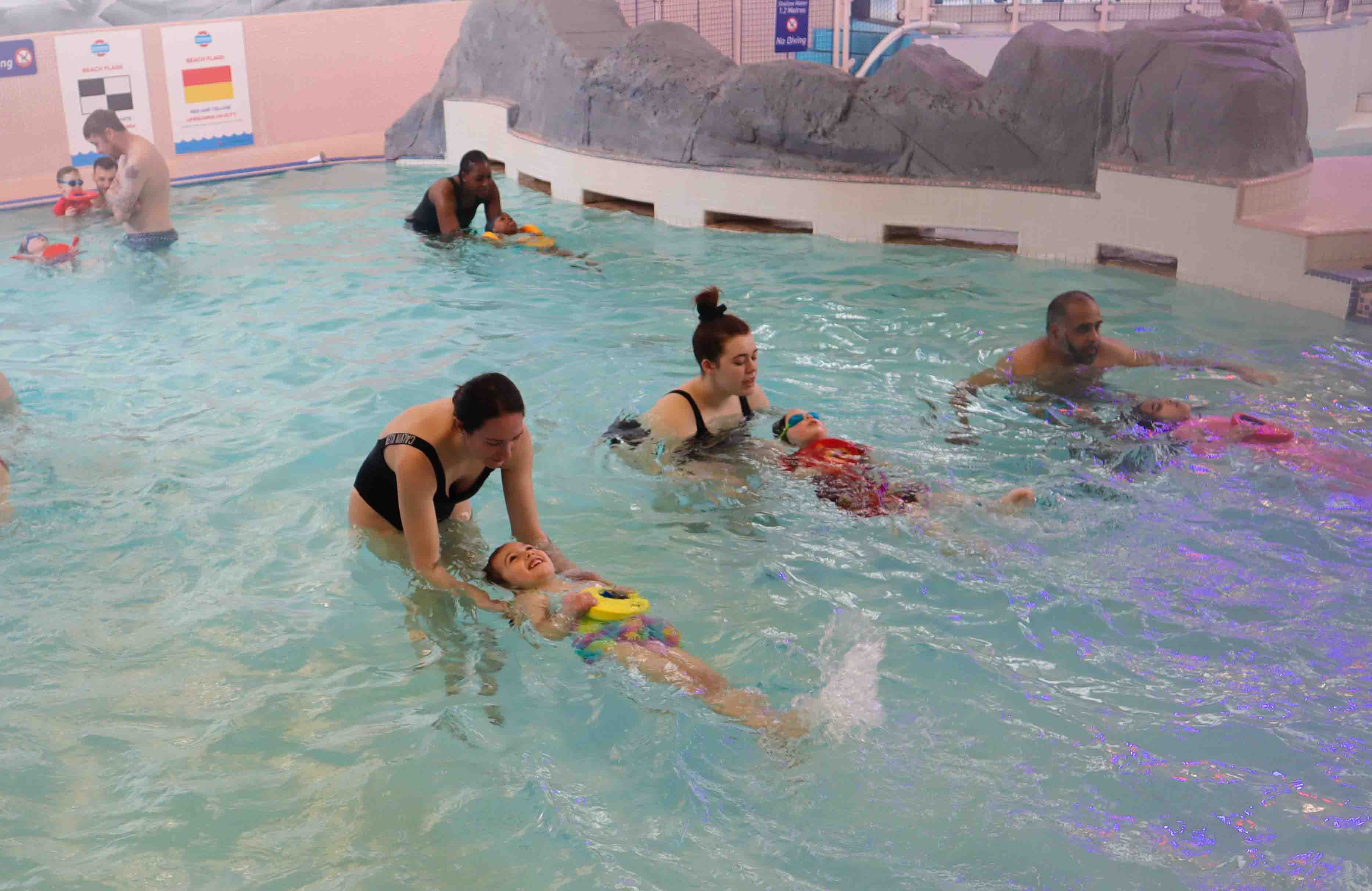 children receiving swimming lessons