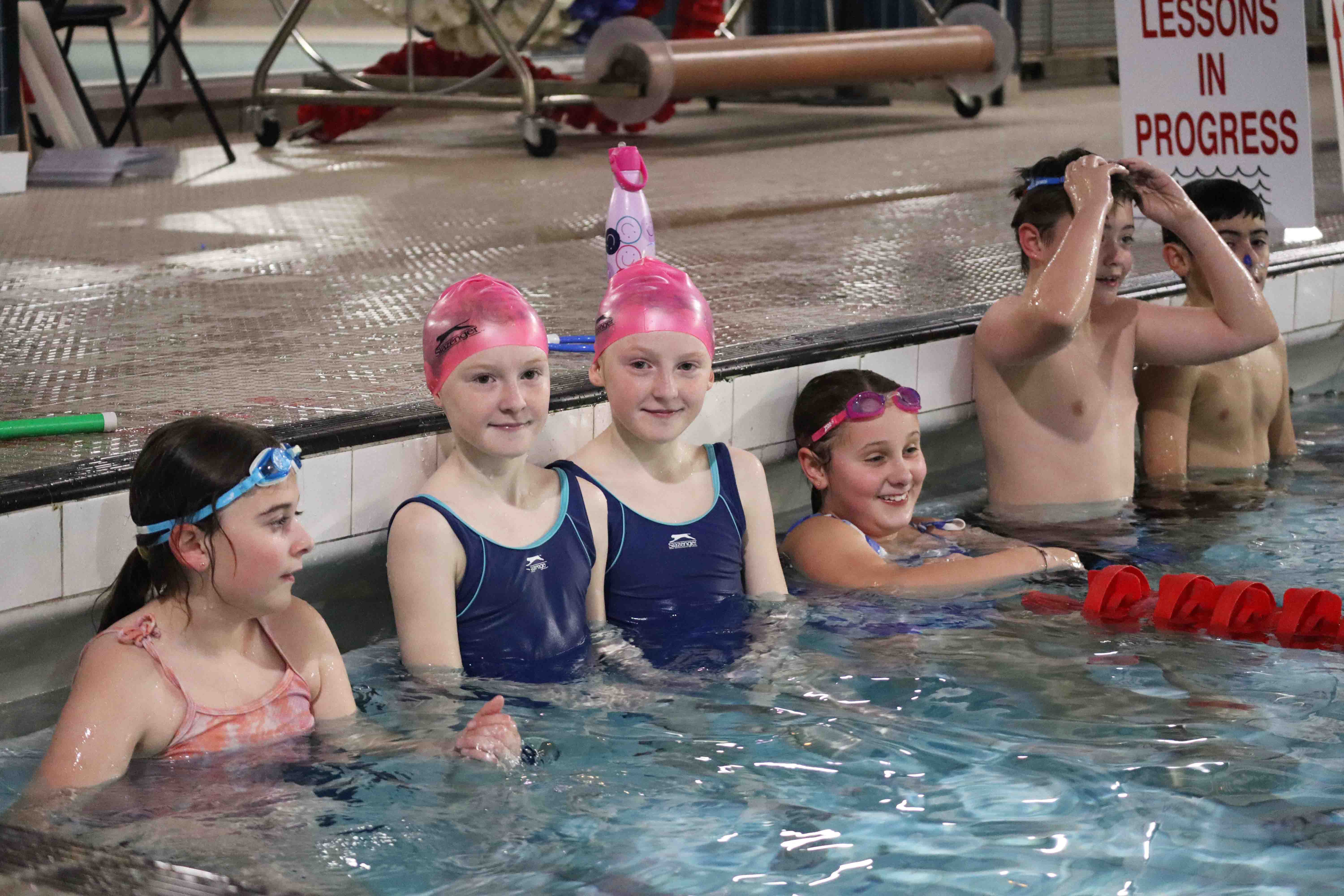 A group of young swimmers together in the pool