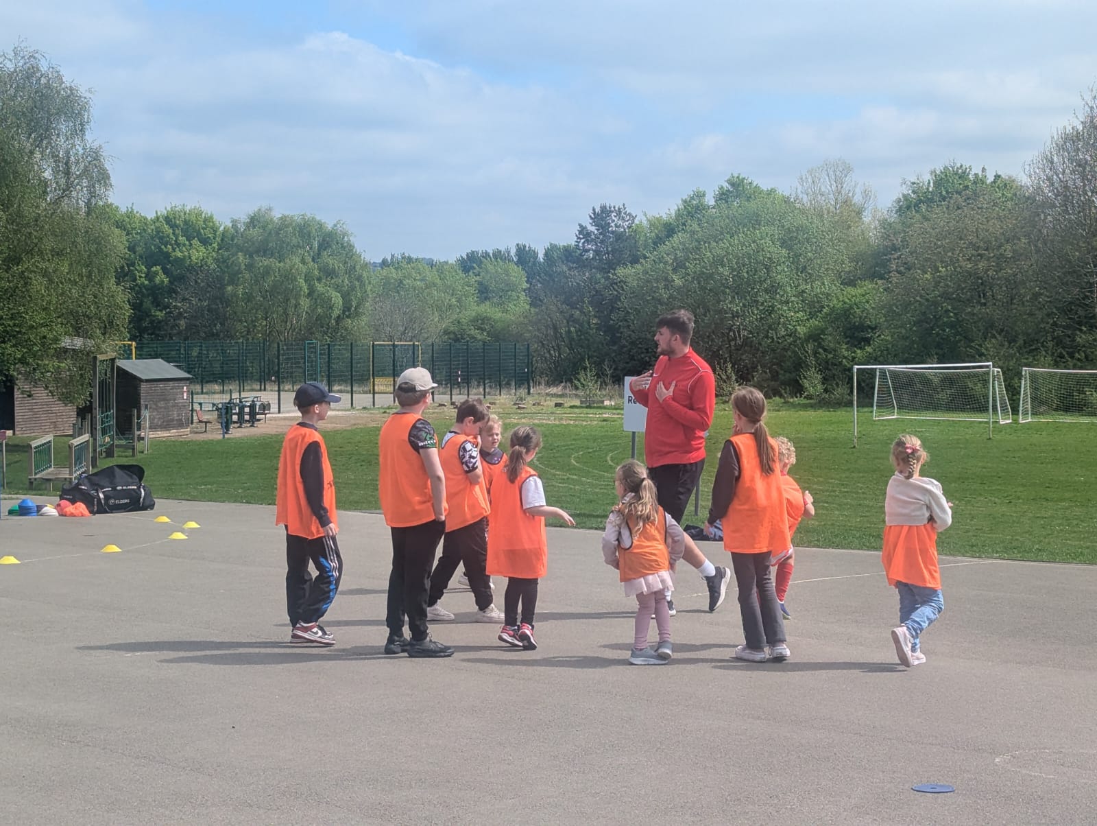 A group of children outside joining in with physical activity