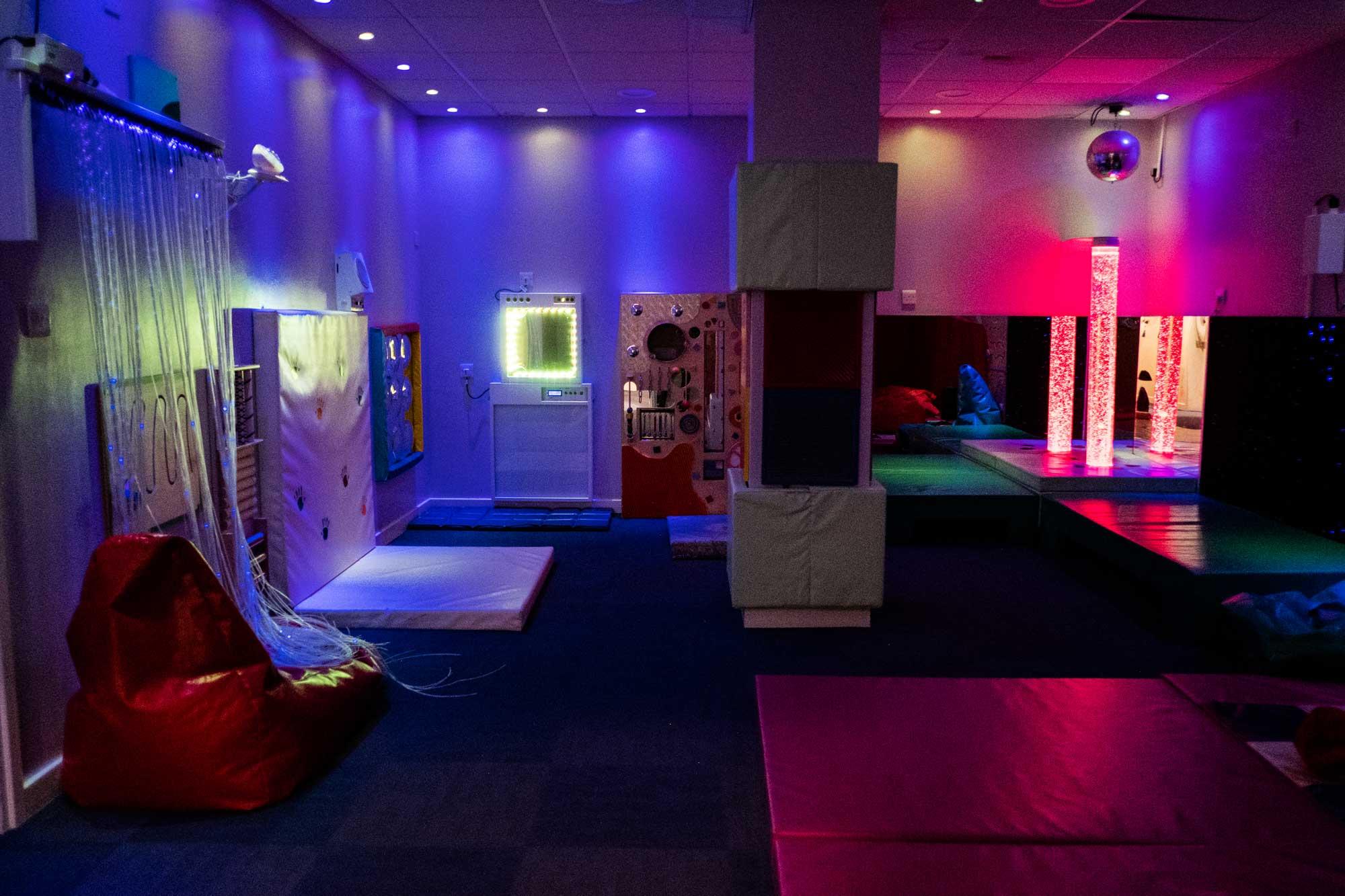 a photo of the sensory room at dimensions featuring soft surfaces and different lighting